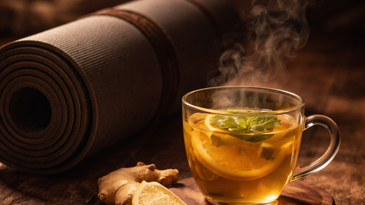 Steaming herbal tea and yoga mat in soft amber light, a serene moment of evening ritual and calm